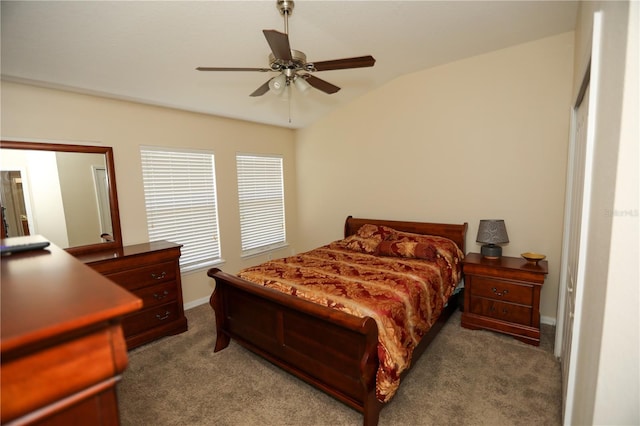 carpeted bedroom with ceiling fan and vaulted ceiling