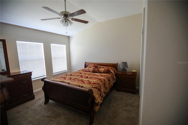 bedroom with dark colored carpet, lofted ceiling, and ceiling fan