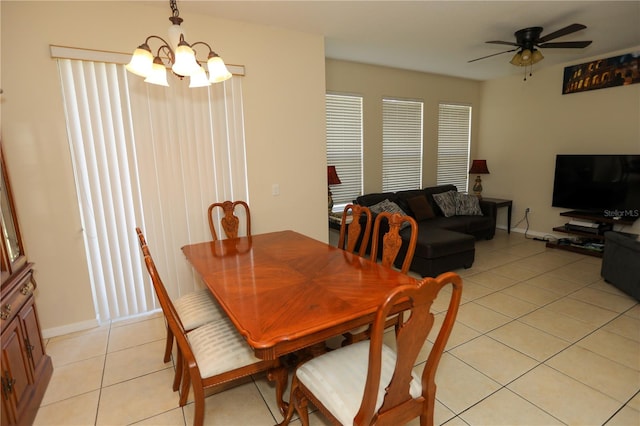 dining area with ceiling fan with notable chandelier and light tile patterned floors