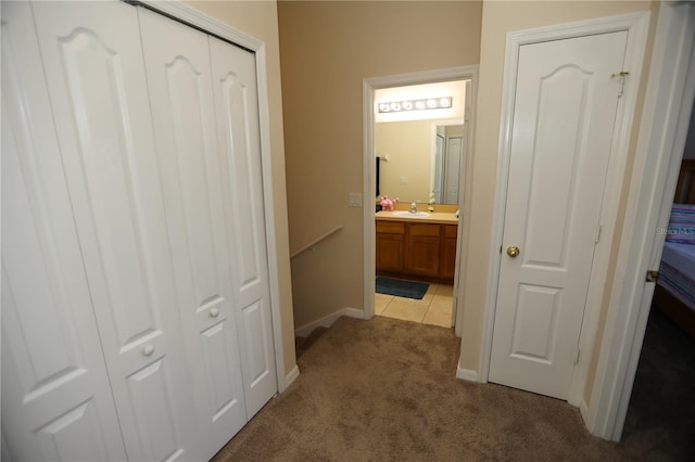 hallway featuring carpet and sink