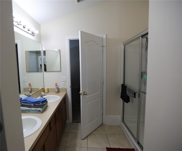 bathroom with vanity, a shower with shower door, tile patterned floors, and a textured ceiling