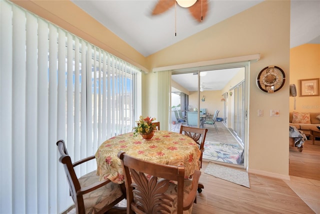 dining space with light wood-type flooring, ceiling fan, and lofted ceiling