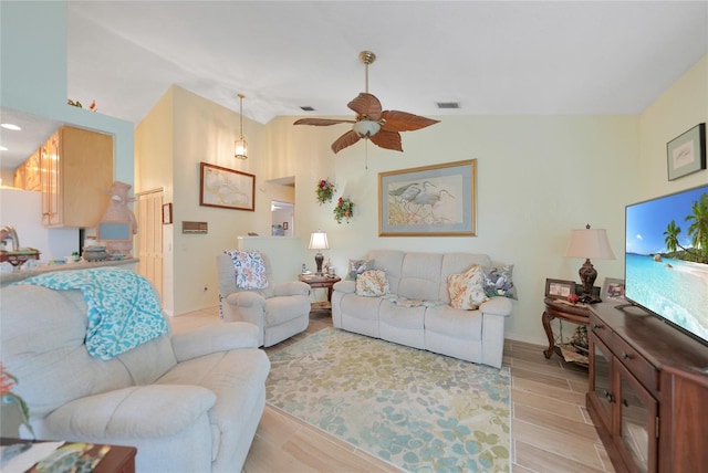 living room with light wood-type flooring, ceiling fan, and lofted ceiling