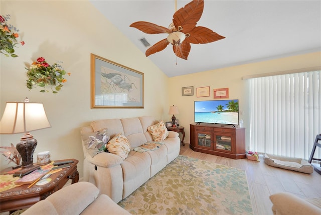 living room featuring light hardwood / wood-style flooring, ceiling fan, and lofted ceiling