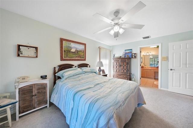 bedroom with connected bathroom, light colored carpet, and ceiling fan