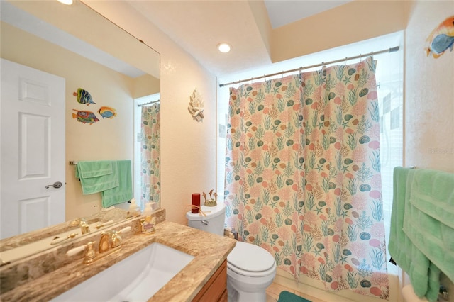 full bathroom featuring tile patterned flooring, vanity, toilet, and shower / tub combo with curtain