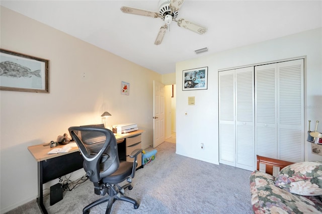 carpeted office space featuring ceiling fan