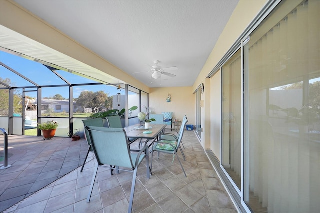 sunroom / solarium featuring ceiling fan