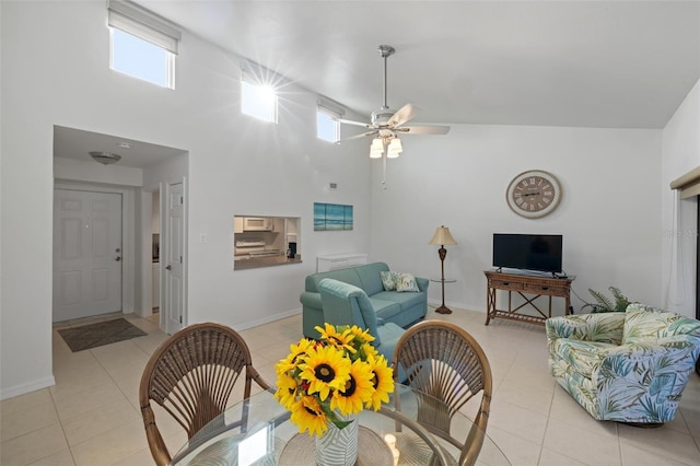 tiled dining room featuring high vaulted ceiling and ceiling fan