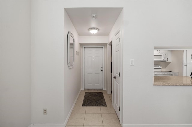 hall featuring light tile patterned flooring