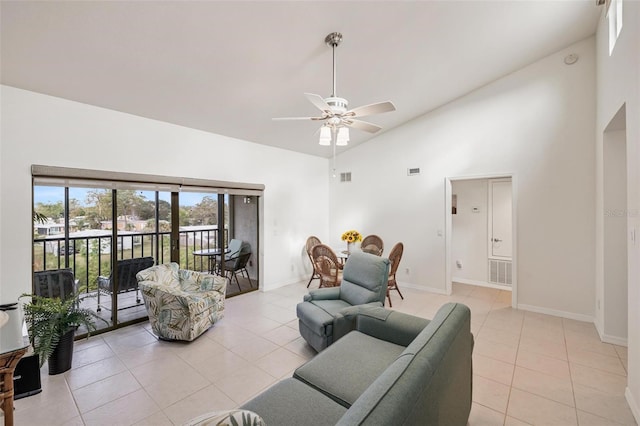 living room featuring ceiling fan, high vaulted ceiling, and light tile patterned floors