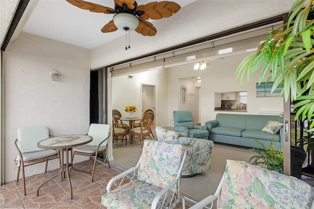 interior space with ceiling fan