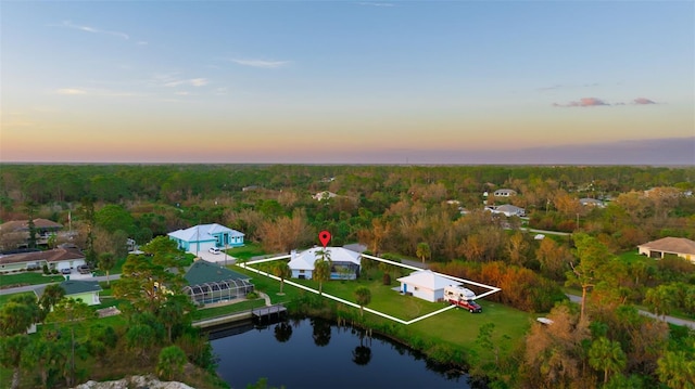 aerial view at dusk with a water view