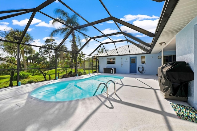 view of pool with a patio, area for grilling, and glass enclosure