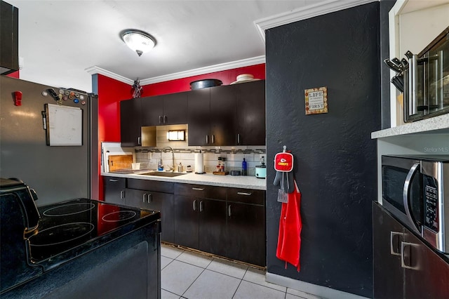 kitchen featuring black range with electric stovetop, backsplash, ornamental molding, light tile patterned flooring, and sink