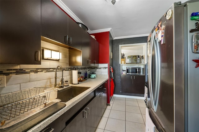 kitchen with ornamental molding, sink, light tile patterned flooring, appliances with stainless steel finishes, and tasteful backsplash