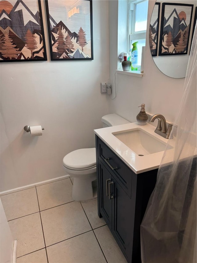 bathroom with vanity, toilet, and tile patterned floors