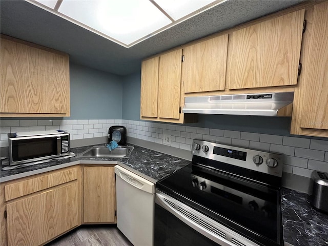 kitchen with appliances with stainless steel finishes, light brown cabinetry, light hardwood / wood-style floors, sink, and ventilation hood