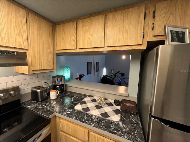 kitchen featuring black range with electric cooktop, stainless steel refrigerator, and decorative backsplash