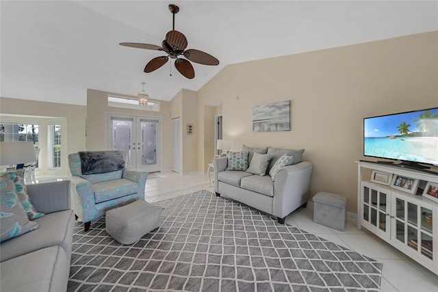 tiled living room with french doors, ceiling fan, and vaulted ceiling