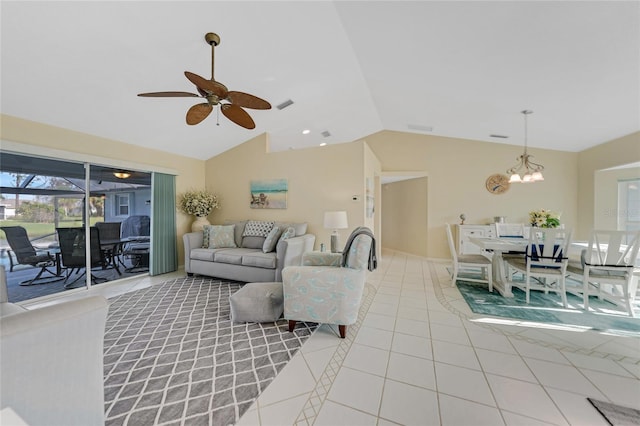 living room featuring vaulted ceiling, light tile patterned floors, and ceiling fan with notable chandelier