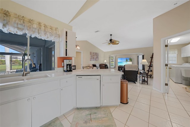 kitchen featuring sink, white dishwasher, lofted ceiling, and white cabinetry