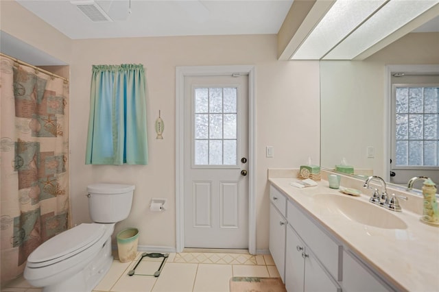 bathroom with vanity, toilet, and tile patterned flooring