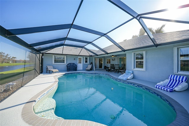 view of swimming pool featuring a patio and glass enclosure