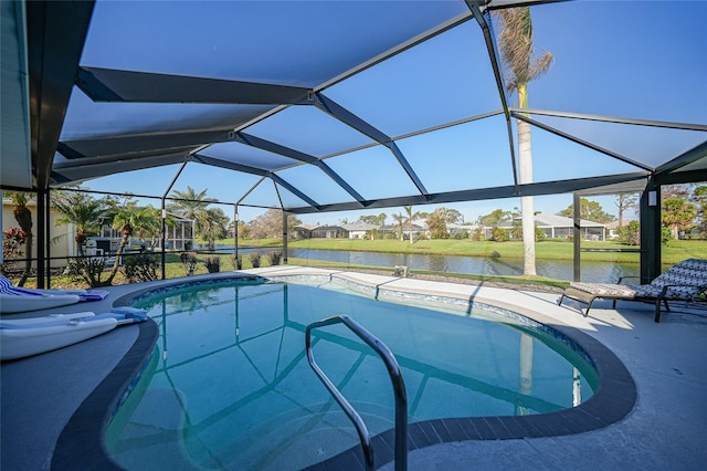 view of pool with a water view, a patio area, and glass enclosure