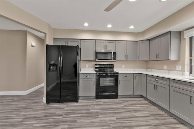 kitchen with black appliances, light countertops, and gray cabinets