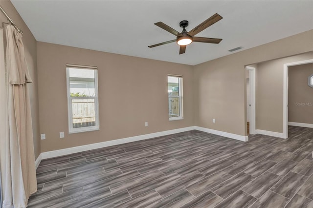 unfurnished bedroom featuring visible vents, baseboards, ceiling fan, and wood tiled floor