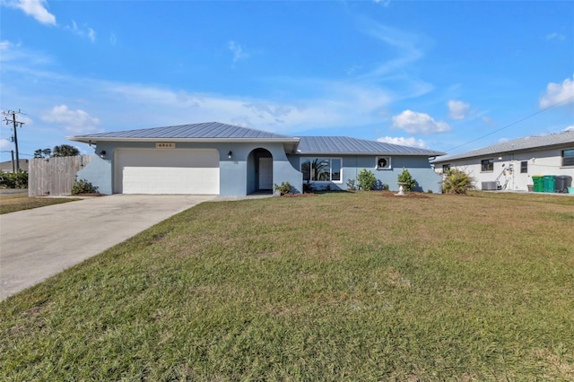 ranch-style home with cooling unit, driveway, an attached garage, stucco siding, and metal roof