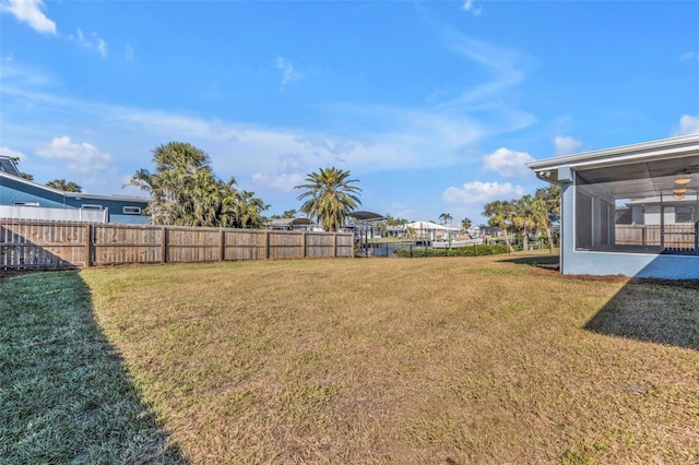 view of yard featuring a sunroom and fence