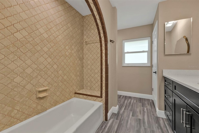 bathroom with vanity, baseboards, wood tiled floor, walk in shower, and a bathtub