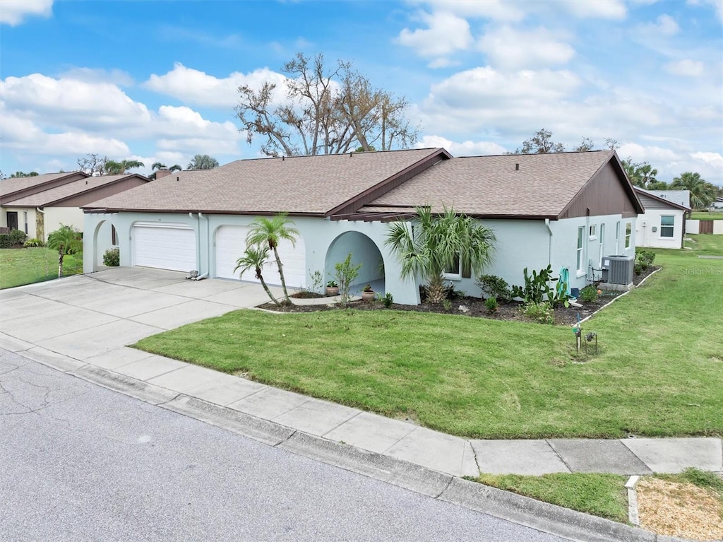 ranch-style home featuring central air condition unit, a front yard, and a garage