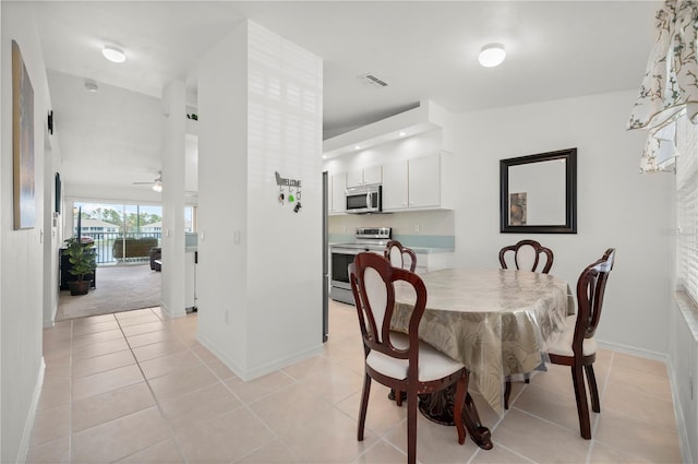 tiled dining room with ceiling fan