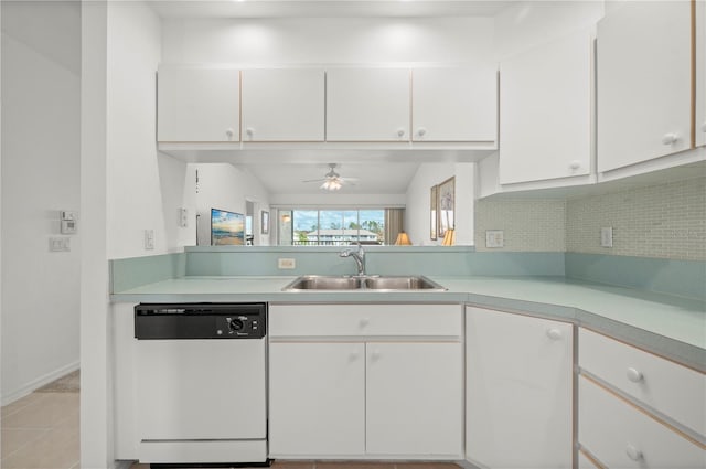 kitchen featuring white cabinets, sink, white dishwasher, and vaulted ceiling