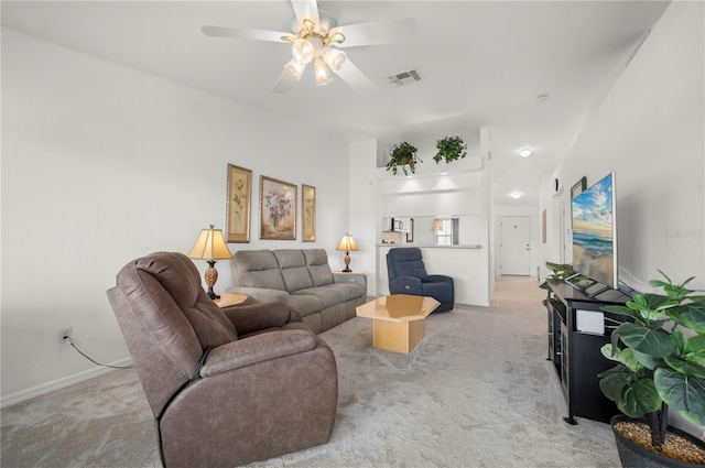 carpeted living room featuring ceiling fan