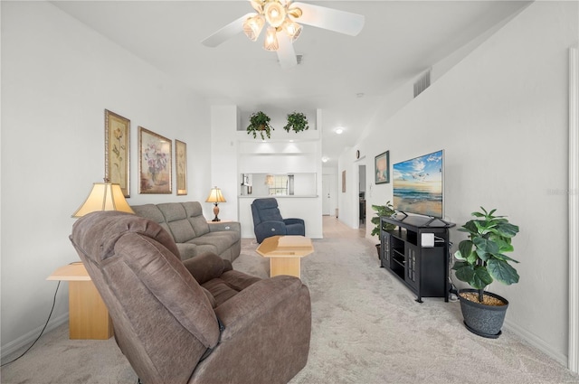 carpeted living room with ceiling fan