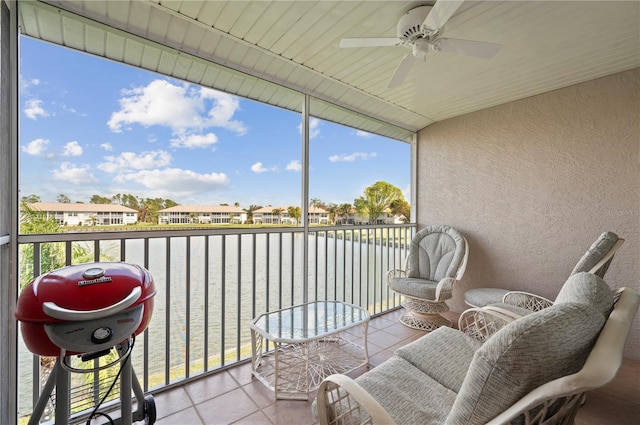 balcony with a water view and ceiling fan