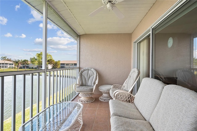 balcony featuring a water view and ceiling fan