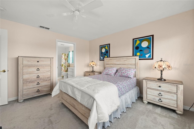 carpeted bedroom with ceiling fan and ensuite bath