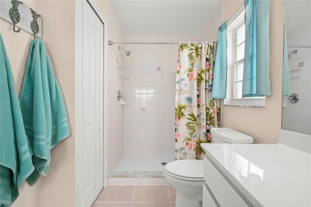 bathroom featuring toilet, a shower with curtain, vanity, and tile patterned flooring