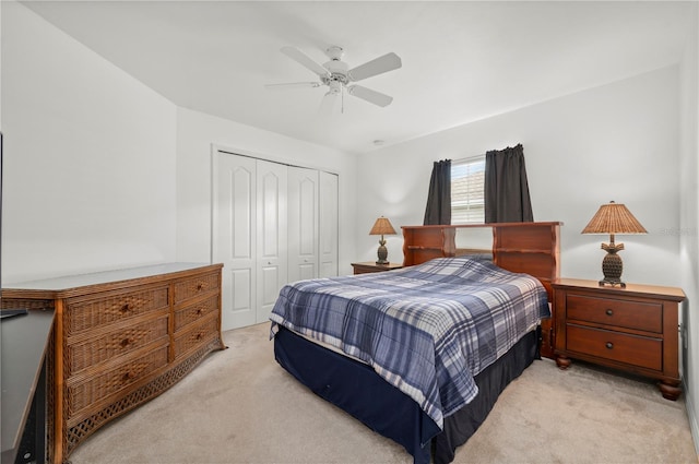 carpeted bedroom with ceiling fan and a closet