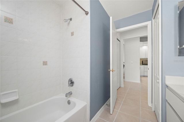 bathroom with tiled shower / bath, tile patterned floors, and vanity