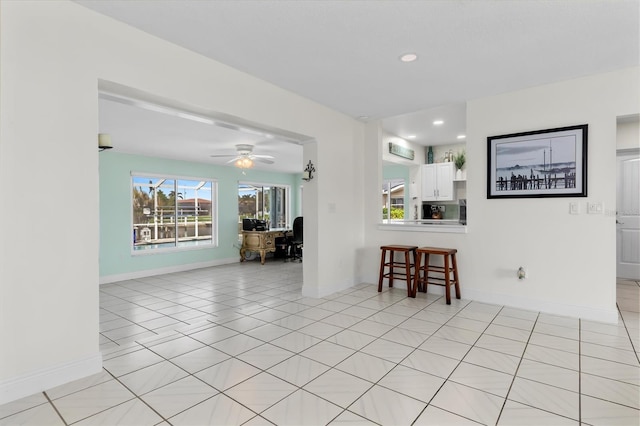 unfurnished room featuring recessed lighting, baseboards, a ceiling fan, and light tile patterned flooring