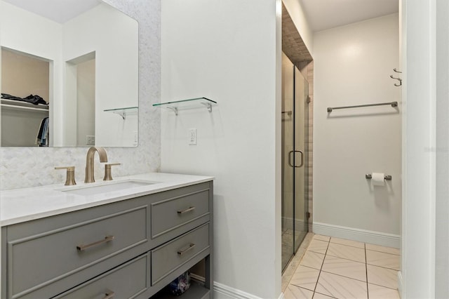 full bath with a stall shower, tasteful backsplash, baseboards, a spacious closet, and vanity