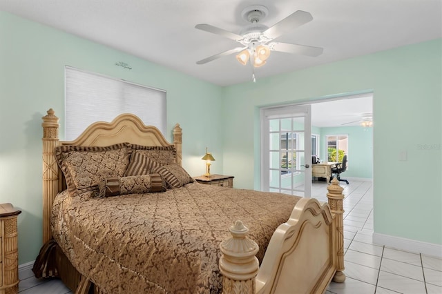 bedroom with light tile patterned flooring, a ceiling fan, and baseboards