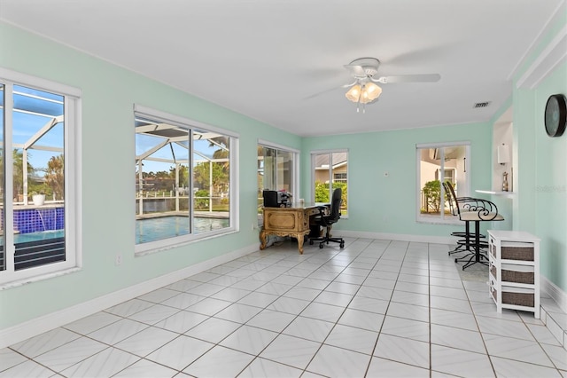 office area featuring light tile patterned floors, baseboards, visible vents, a sunroom, and ceiling fan