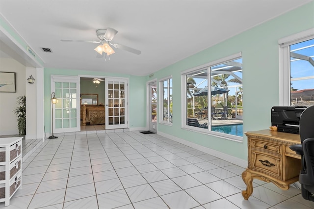 sunroom with a ceiling fan and visible vents